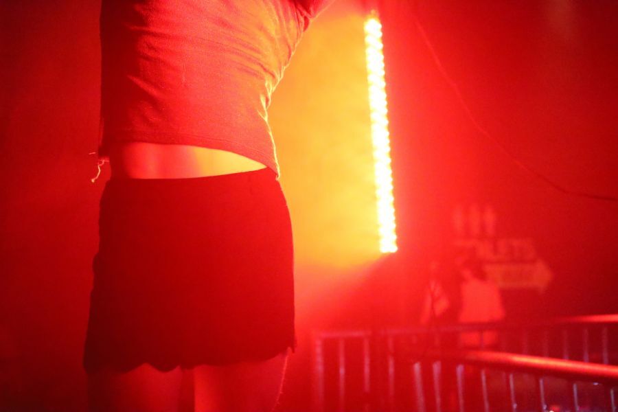 A warm orange glow with a close up of a person's torso as they dance.