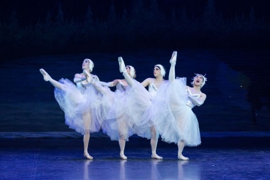 Four male ballerinas dance to Swan Lake