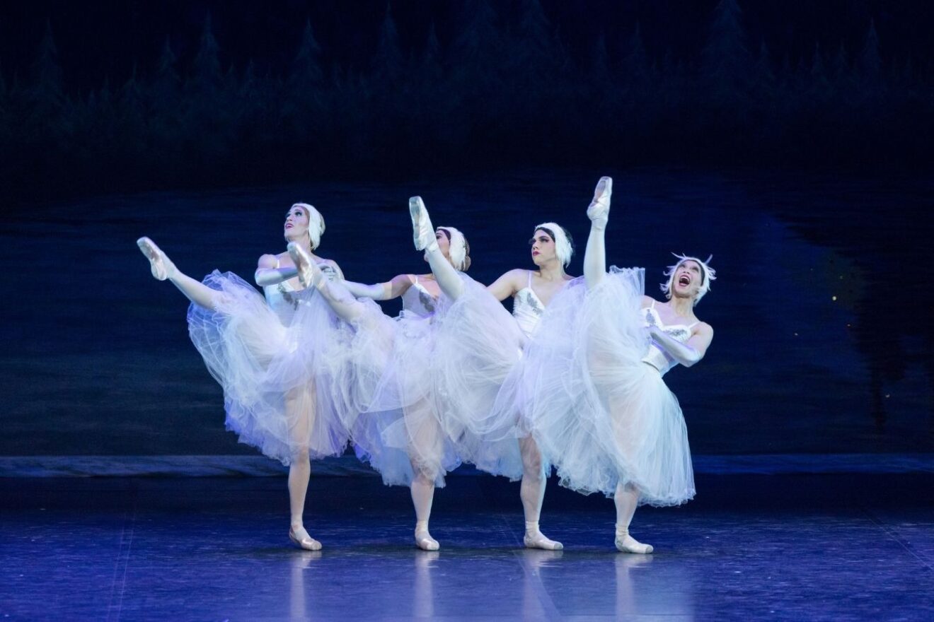 Four male ballerinas dance to Swan Lake