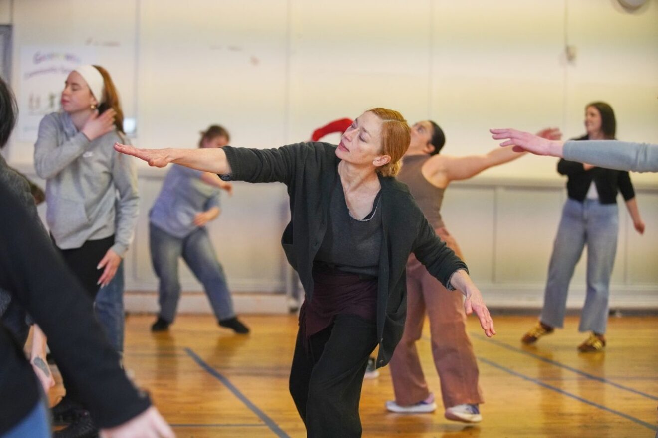 A group of people take part in a movement workshop in a studio